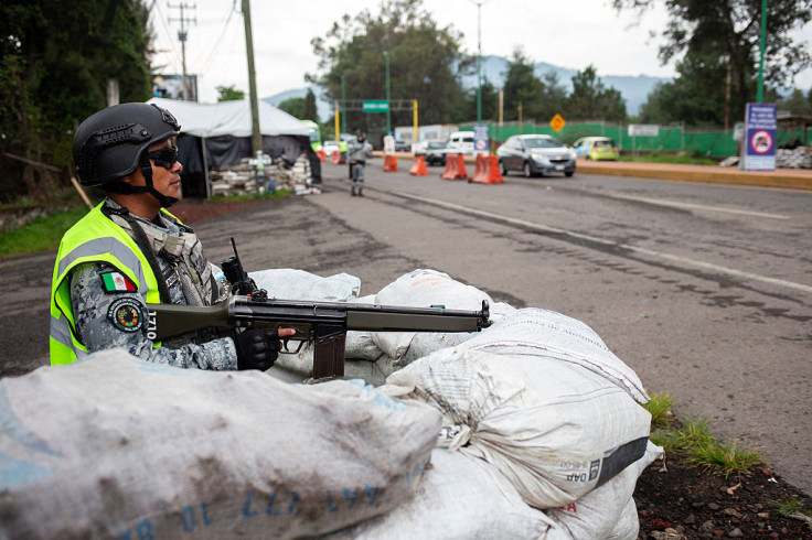 National Guard member stands guard at an access point to
