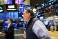 Traders work on the floor of the NYSE in New York